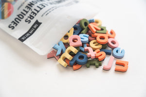 Colorful magnetic letters and shapes on a refrigerator door