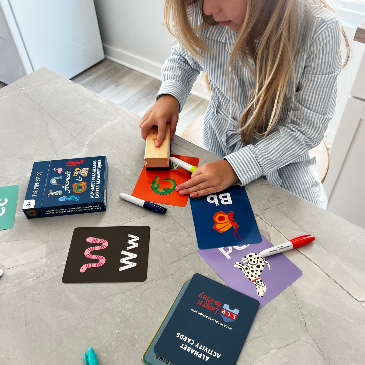 Child playing with educational alphabet flash cards