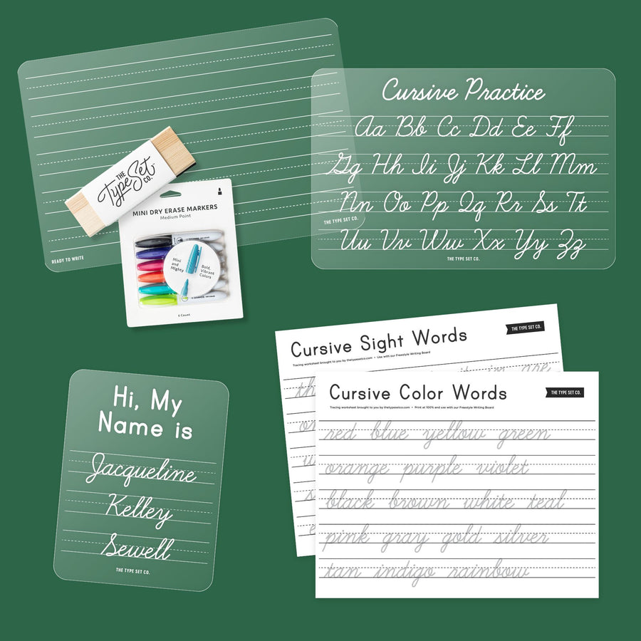 A cursive handwriting practice set arranged on a dark green background, including clear lined practice sheets, a name-reading sign, a mini dry-erase marker package, and printed practice pages titled Cursive Practice, Cursive Sight Words, and Cursive Color Words.