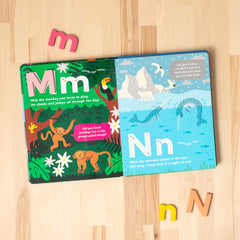 Open spread of 'Curious Creatures from A to Z' featuring M for Monkey and N for Narwhal.