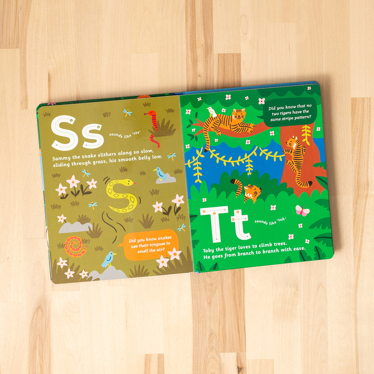 Open spread of 'Curious Creatures from A to Z' featuring S for Snake and T for Tiger.