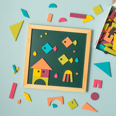 Geometric shape magnets making underwater scene on green chalkboard on blue background