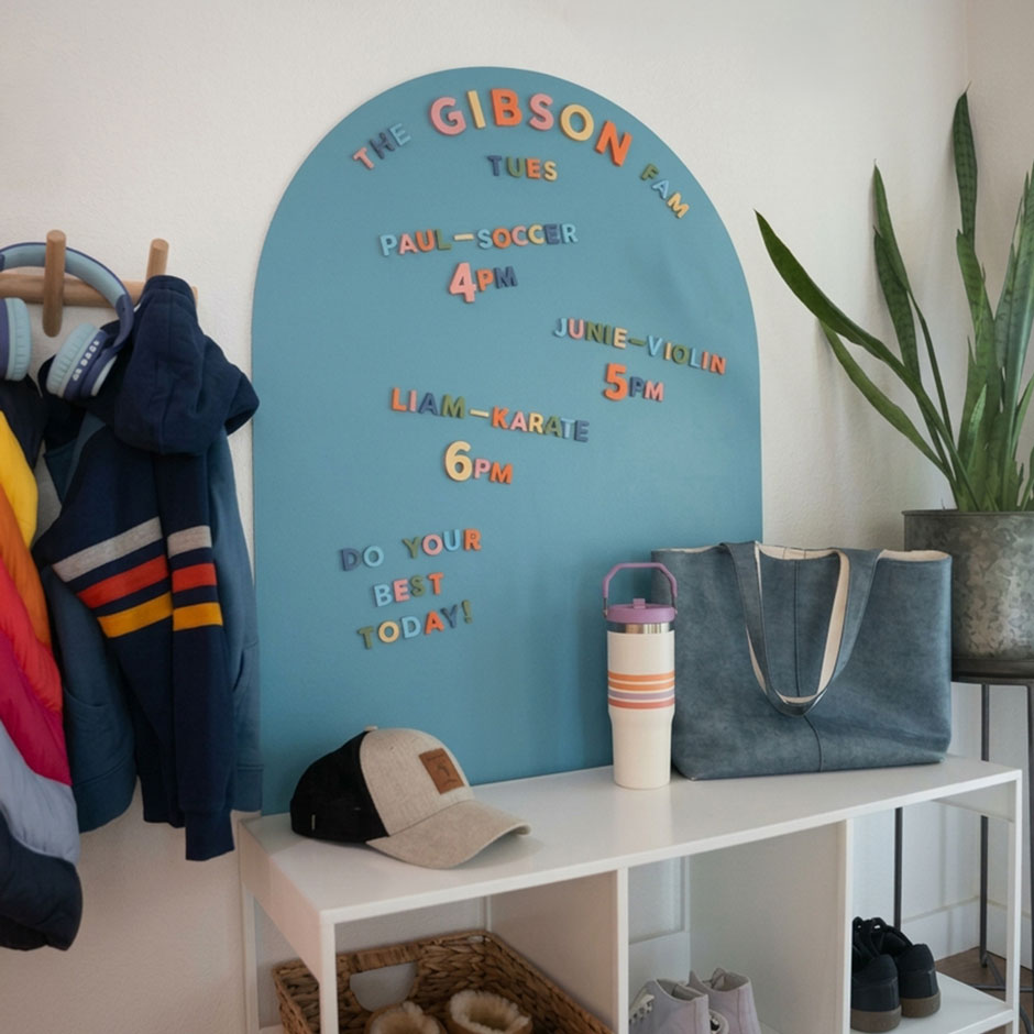 Entryway featuring medium blue arched wall decal with colorful alphabet magnets displaying family activities.