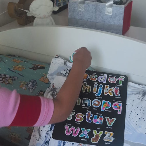 Video of a boy peeling lowercase animal alphabet stickers off the sheet and spelling his name, Gabriel, on his headboard.